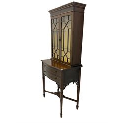Early 20th century mahogany display cabinet on stand,  the cabinet enclosed by two astragal glazed doors, shaped stand fitted with two drawers on square tapering supports with spade feet