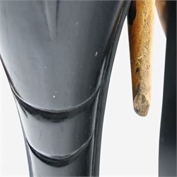 Elephant ebonised jardinière, moulded circular top raised on carved Elephant supports united by a shaped undertier