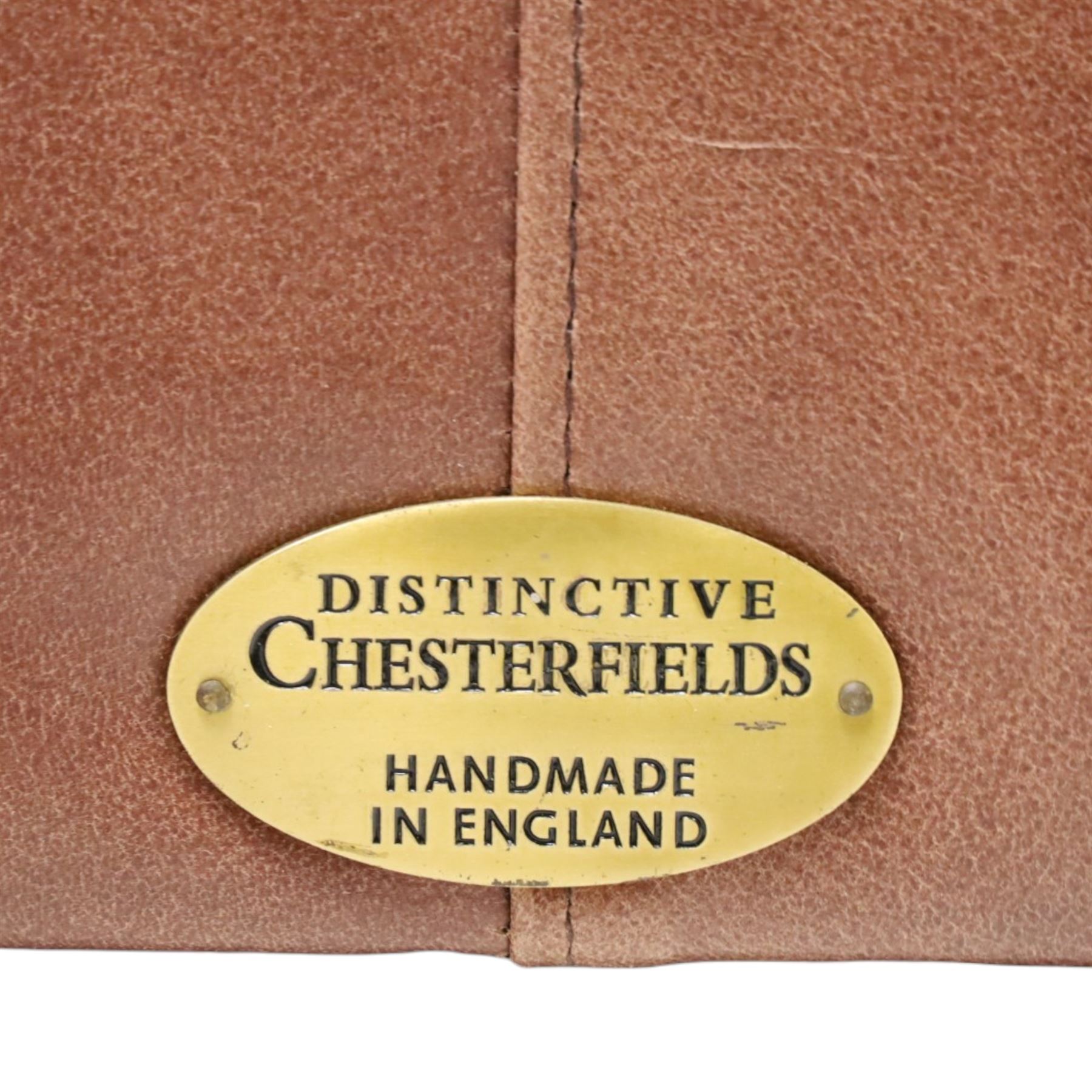 Distinctive Chesterfield - full buttoned tan brown leather sofa, deep buttoned back, seat and arms, raised on dark stained supports terminating in brass castors 
