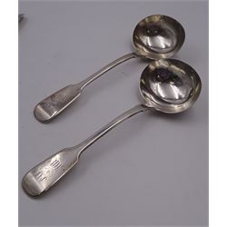 Group of Victorian silver fiddle pattern spoons, comprising pair of sauce ladles and set of six teaspoons, both hallmarked Henry Holland (of Holland, Aldwinckle & Slater), London 1857, set of four table spoons, hallmarked Chawner & Co (George William Adams), London 1857, and set of six dessert spoons, hallmarked Chawner & Co (George William Adams), London 1856, with monogrammed terminals, approximate total silver weight 25.50 ozt (792.6 grams)