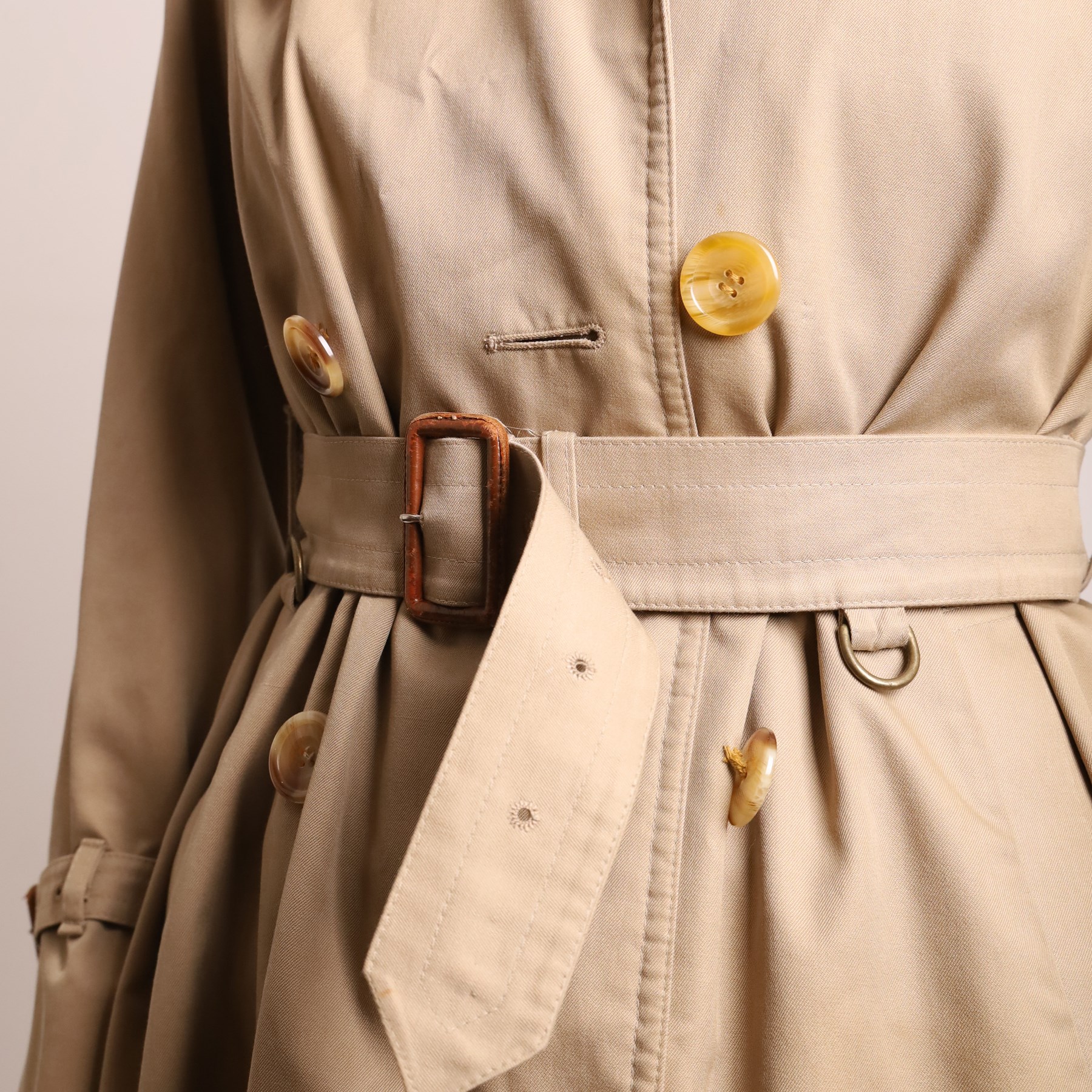 Aquascutum – vintage beige ‘Aqua 5’ trench coat, made in England, with double-breasted button fastening, storm flap, epaulettes, belted waist and cuffs, slash pockets and signature checked lining, size M