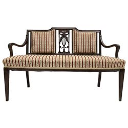 Edwardian mahogany framed three-piece salon suite - two-seat sofa, stepped cresting rail over acanthus and scroll carved pierced splat, upholstered in striped fabric (W124cm, H87cm, D62cm); and a pair of matching armchairs (W60cm) 