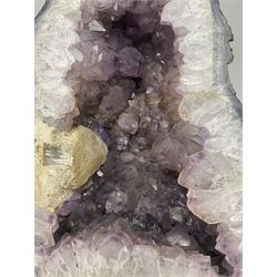 Amethyst crystal ‘cathedral’ geode, free standing with flat base and prepared outer surface, with well-defined crystals of various sizes within the cavern, H39, L32cm