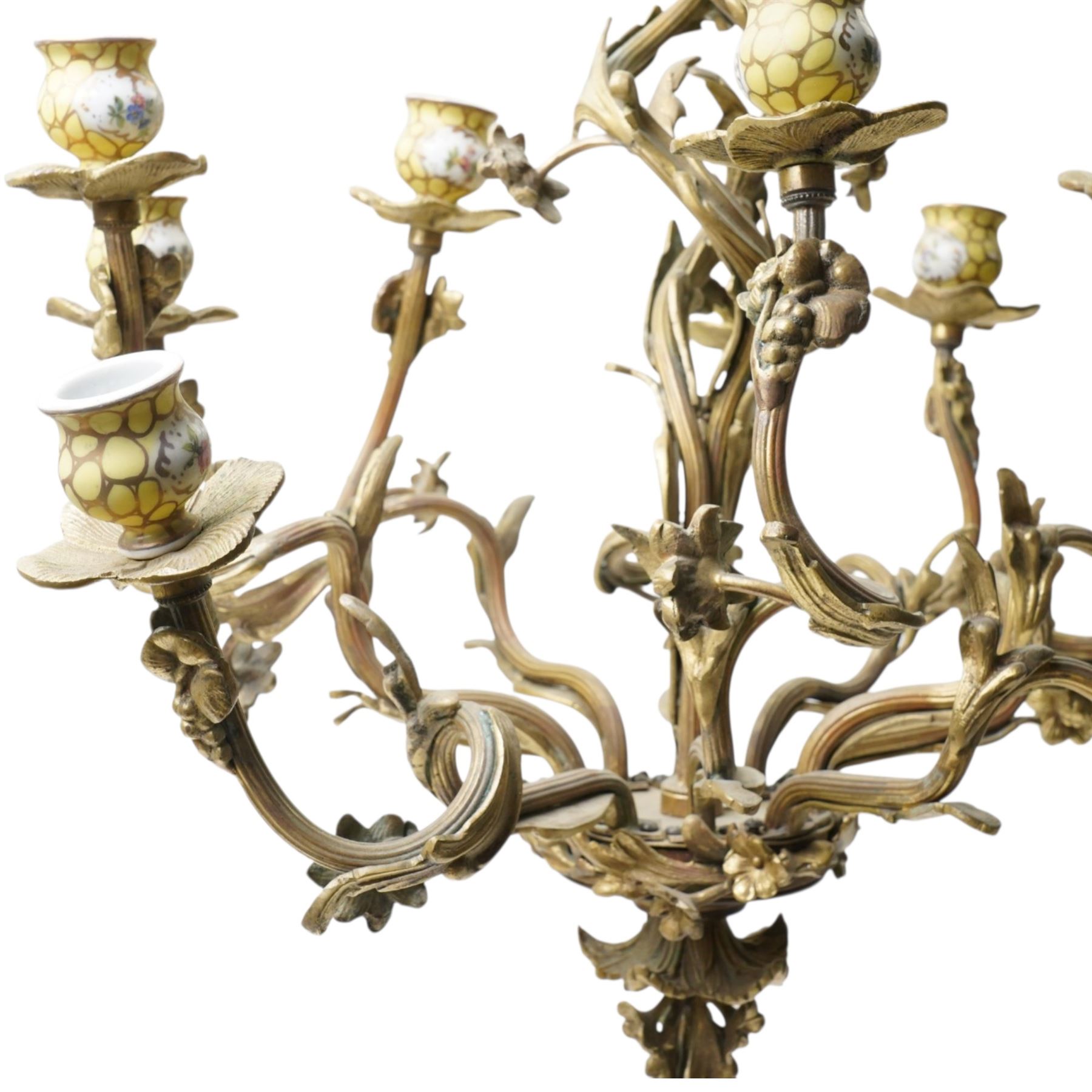 Rococo design brass ten light chandelier with scroll branches and ceramic candle holders H74cm