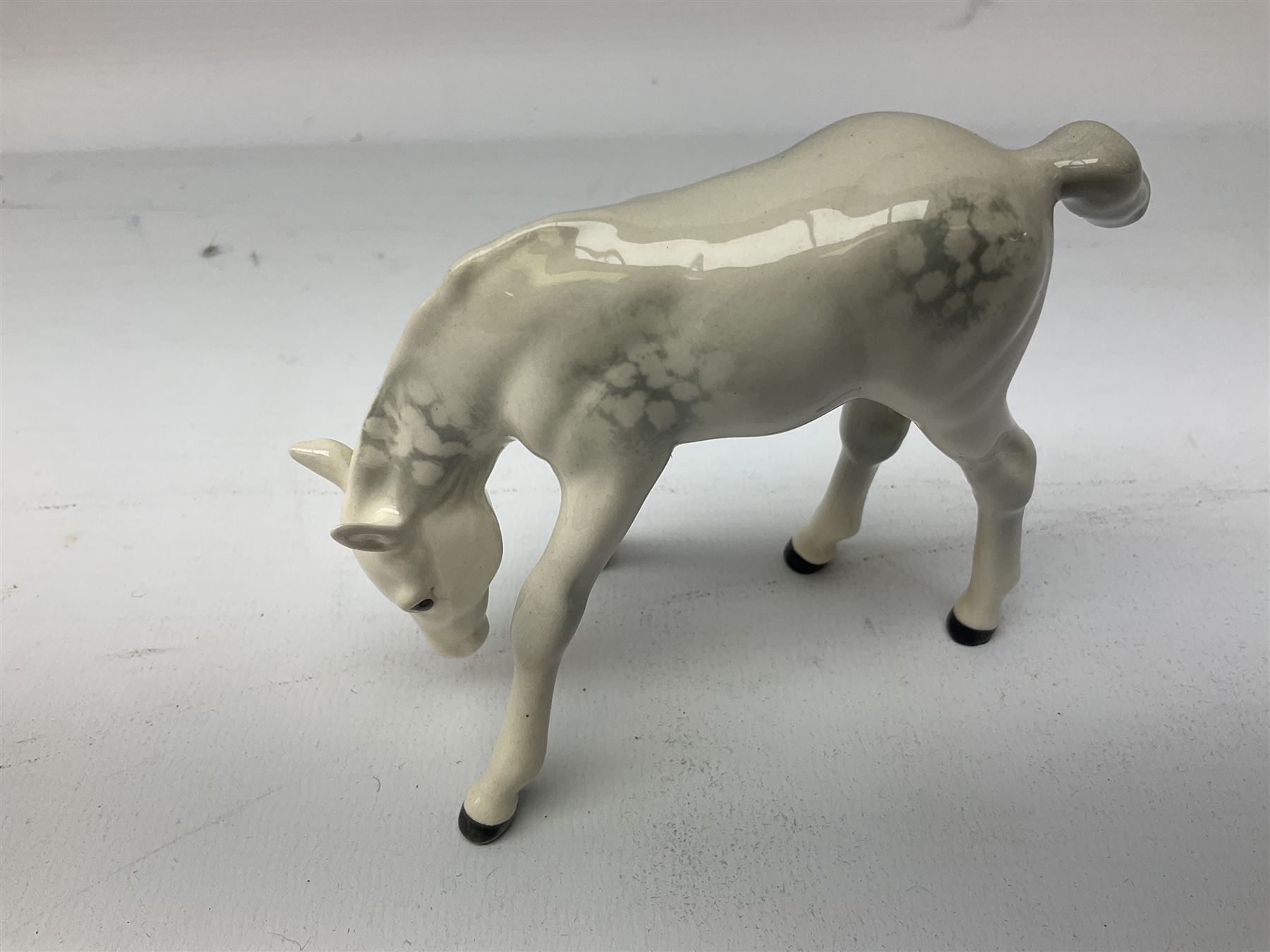 Collection of Beswick horses, including grey horse no.701, palomino foal no 836, grey stocky jogging mare no.855 etc, together two Royal Doulton horses, (8)