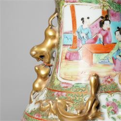 Cantonese famille rose vases, of inverted baluster form, the domed cover with gilt dog of Fu finial, H38cm; together with a further pair of Cantonese vases, each with double Buddhist lion handles and applied at the shoulders with chilong, H45cm (3)
