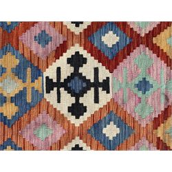 Kilim pastel ground rug, the field decorated with repeating multicoloured geometric diamond motifs, enclosed within matching geometric borders