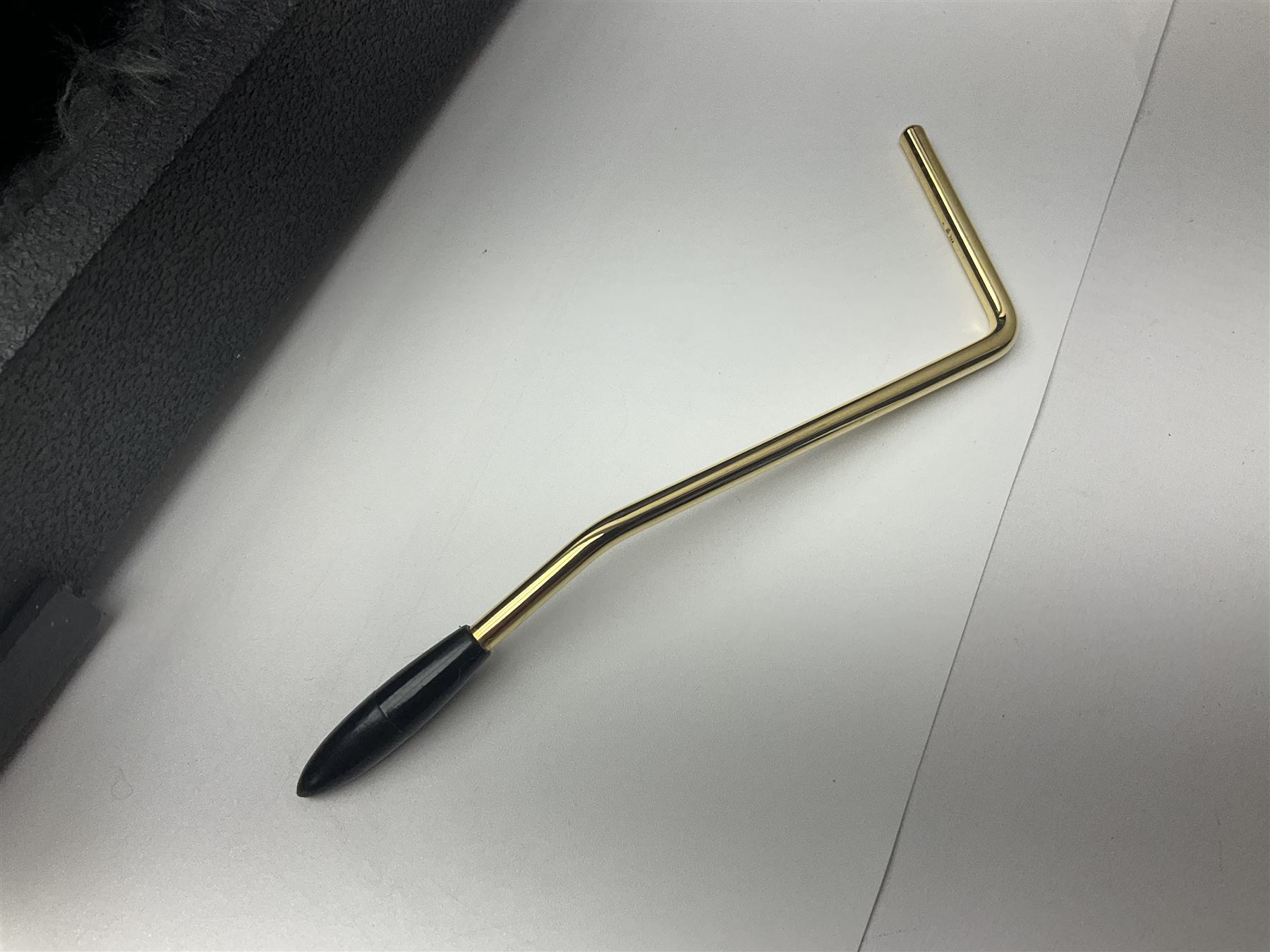 Copy of a Fender Stratocaster electric guitar in black with Wilkinson bridge, lock-in tuners, synchronised tremolo and various patent numbers; L99cm; in hard carrying case with strap and digital tuner