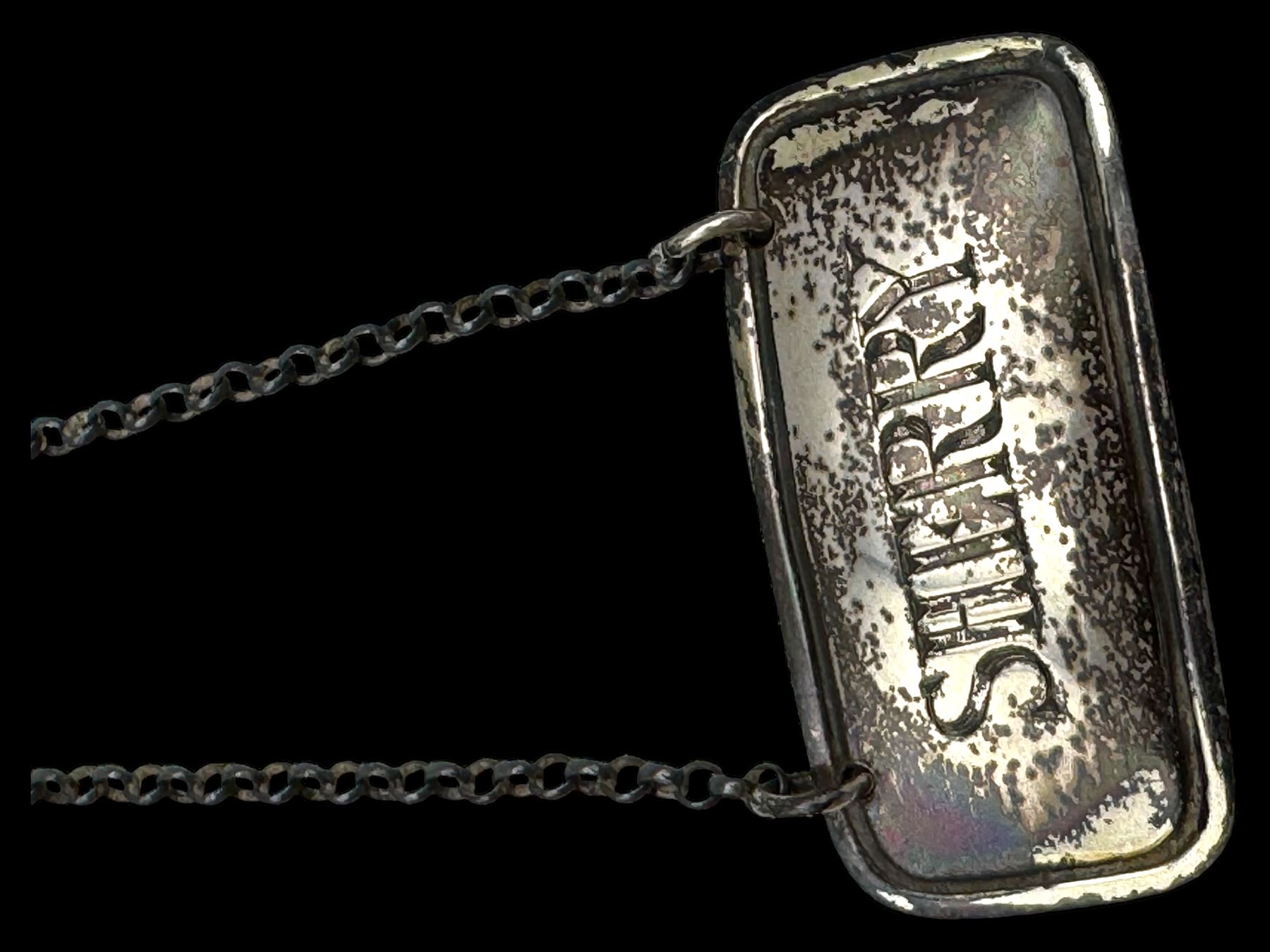 Three silver decanter labels and a collection of silver and silver plated cutlery