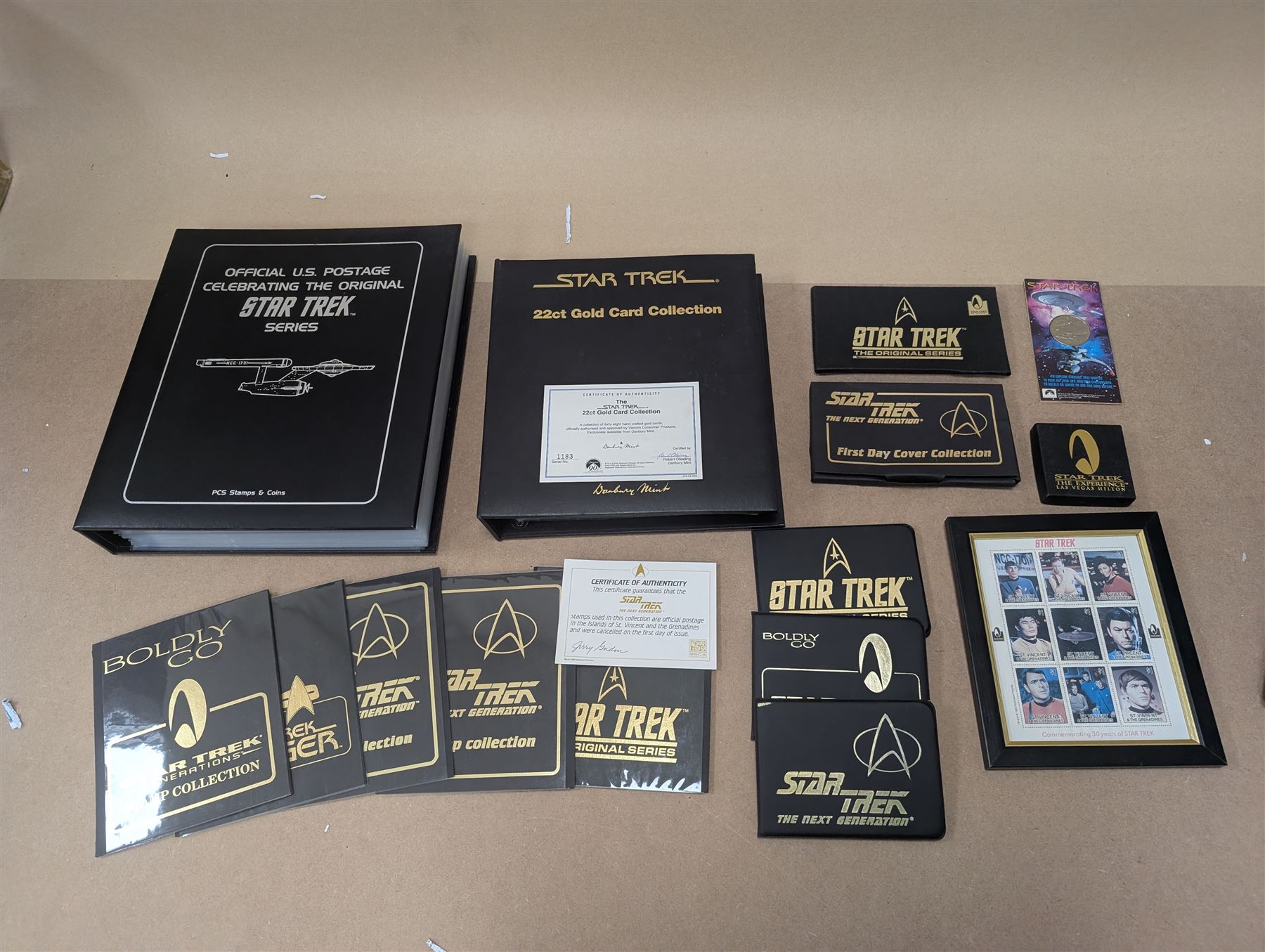 Star Trek collectables, including Danbury Mint '22ct Gold Card Collection', PCS Stamps and Coins Official US Postage Celebrating The Original Star Trek Series, Star Trek St Vincent and Grenadines first day cover collection, four stamp sets and a framed set of similar stamps, commemorative coins, Star Trek The Experience Las Vegas coin, three commemorative 'gold stamps' and three albums of collectors cards and telephone cards