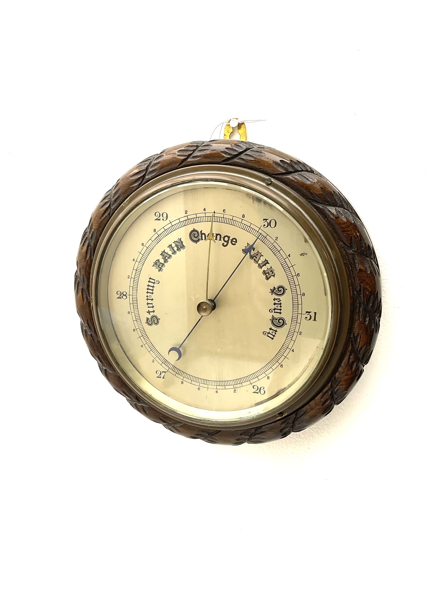 Mid 20th century circular oak cased barometer, silvered dial with register, rope carved edge moulding