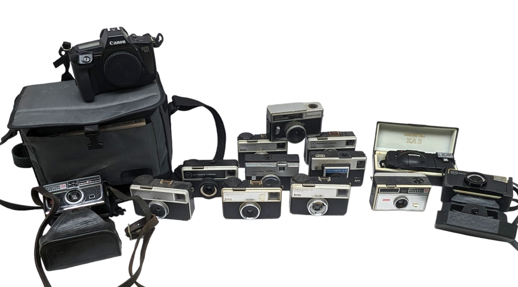 Canon EOS 650 camera, serial no 2122736, in carry case with some accessories, together with an Olympus XA2 camera and ten Kodak Instamatic cameras and two similar