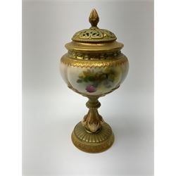 A Royal Worcester potpourri vase and cover, shape 1813, the bulbous body hand painted with pink roses and signed A Watkins, supporting a gilded and burnished pierced cover, upon a moulded stem with zoomorphic mask detail and circular foot, with puce printed mark beneath, H24cm