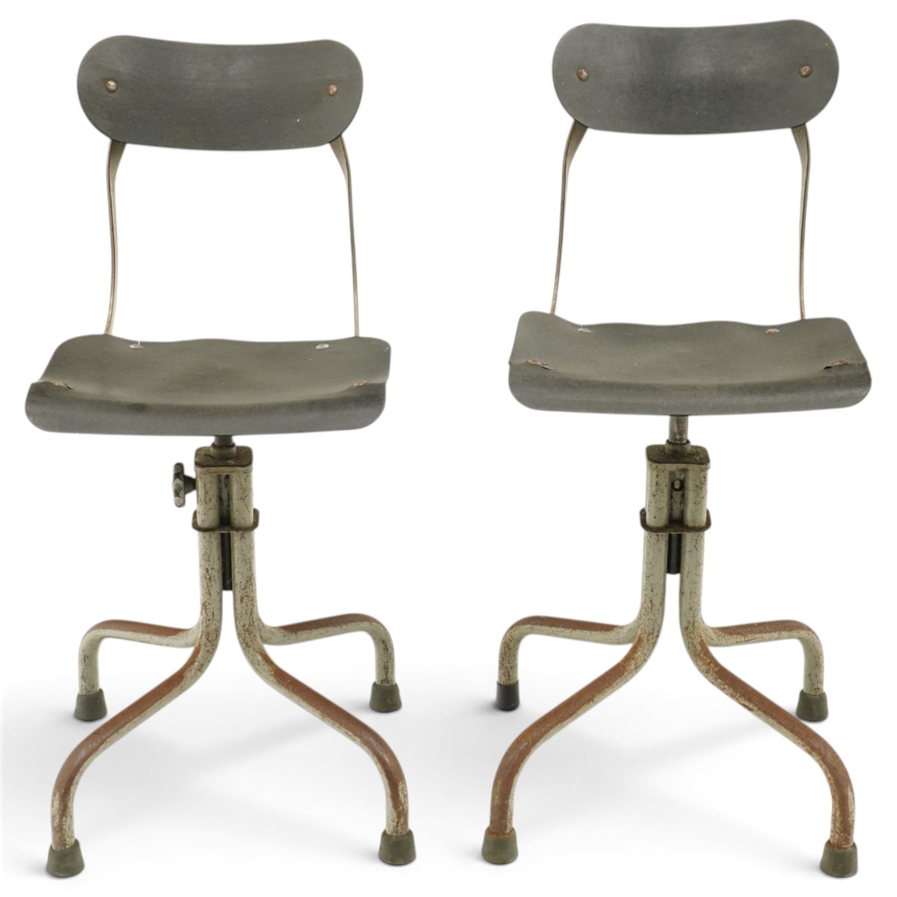 Pair of mid 20th century 'Tan-Sad' industrial chairs, black moulded fibre seats, raised on four supports