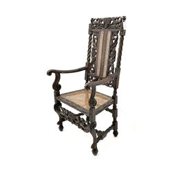 Victorian style heavily carved and pierced oak armchair, cane work seat and back, scrolling arms and supports, rope twist stretchers,  raised on ball and claw feet 