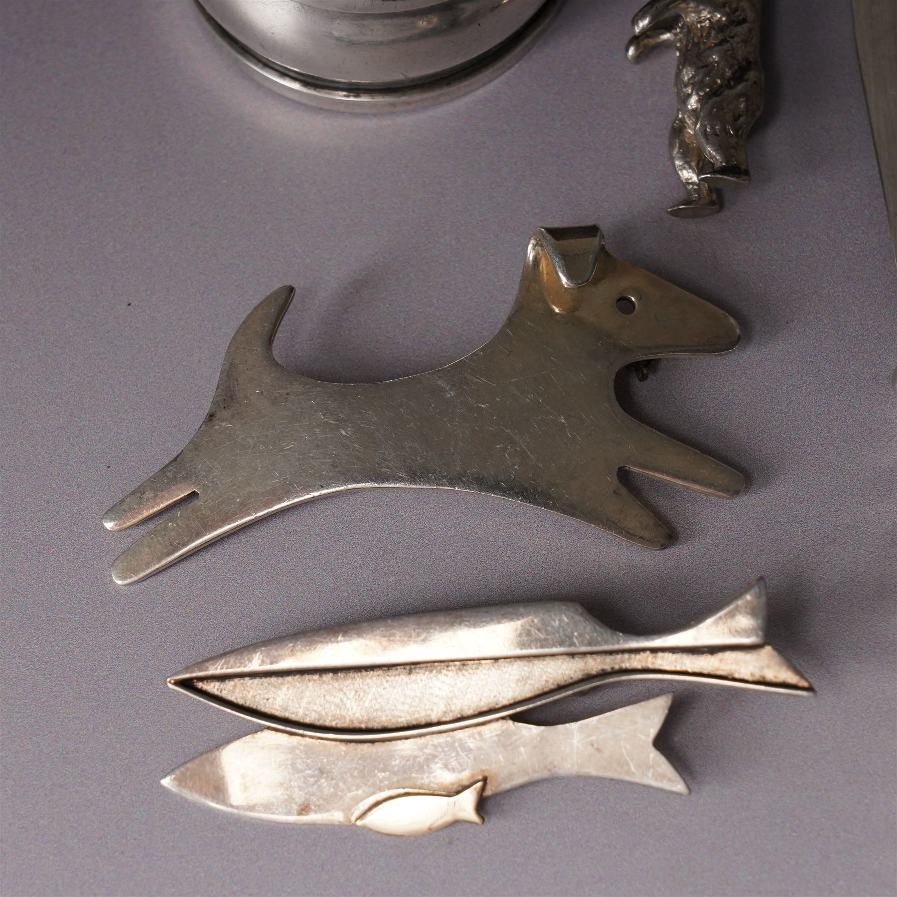 Assorted silver including two 19th century condiment spoons, coffee spoon, napkin ring, knife, two silver brooches and a charm 