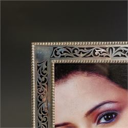 Indian silver folding double photograph frame, of rectangular form, with beaded border and pierced decoration, H22cm