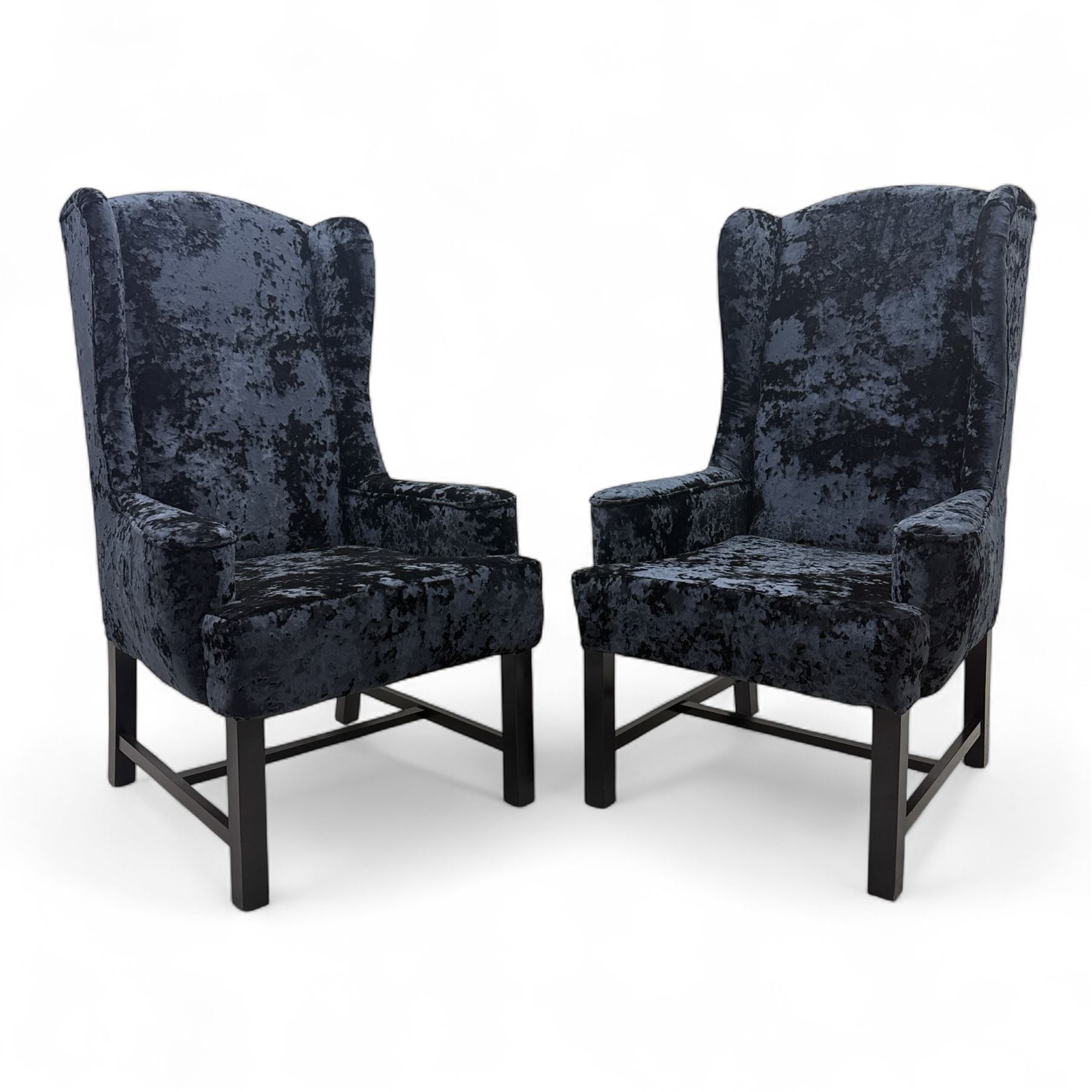 Oka - Pair of contemporary upholstered wingback armchairs, in black and blue textured velvet effect fabric, with tall scroll wing sides and square tapered legs joined by stretchers