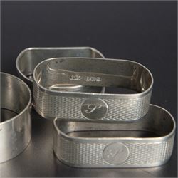 Five silver napkin rings, including pair of 1930s oval examples, with engine turned decoration with engraved initial, together with a collection of silver flatware, including Norwegian spoon, pair of Fiddle pattern mustard spoons, five seal top coffee spoons, etc, all stamped or hallmarked