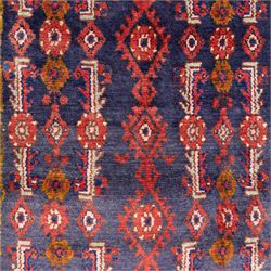 North West Persian Cirjan hand-knotted rug, indigo field decorated with vertical columns of stylized boteh, rosettes and diamond devices arranged in a repeating lattice and a chain of linked lozenges, enclosed by a mustard gold inner border and a principal border of madder ground, flanked by narrow guard stripes, with cotton fringe ends 