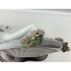 Lladro figure, Garden of Dreams, modelled as a woman reclining in front of trellis of flowers on a mahogany base, limited edition 3129/4000, sculpted by  José Puche, with original box, no 7634, year issued 1994, year retired 1996, H32cm