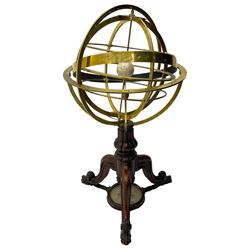 19th century brass terrestrial armillary sphere on rosewood base, lobe carved column on three splayed supports with scrolled carved terminals, the supports united by circular compass with turned stretchers