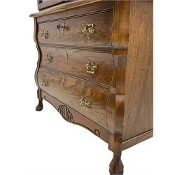 Dutch style oak vitrine on bomb chest, shaped pediment over two glazed doors, the chest fitted with three drawers