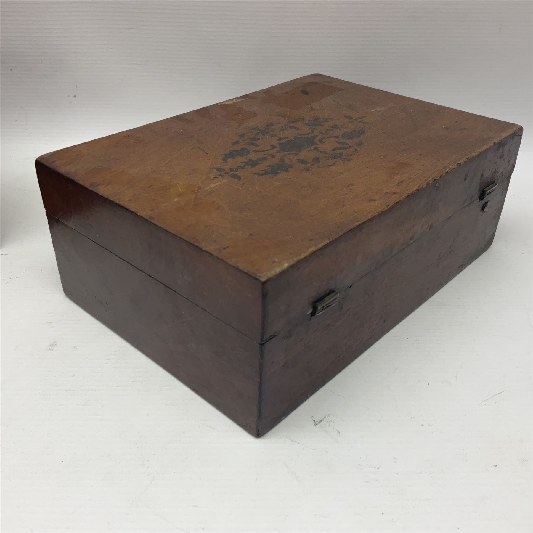 Walnut dressing table box, set with mother of pearl cartouche, opening to reveal a compartmentalised interior with mirror, covered in parts in purple velvet, together with a smaller jewellery box with stencil print, dressing table box H15cm