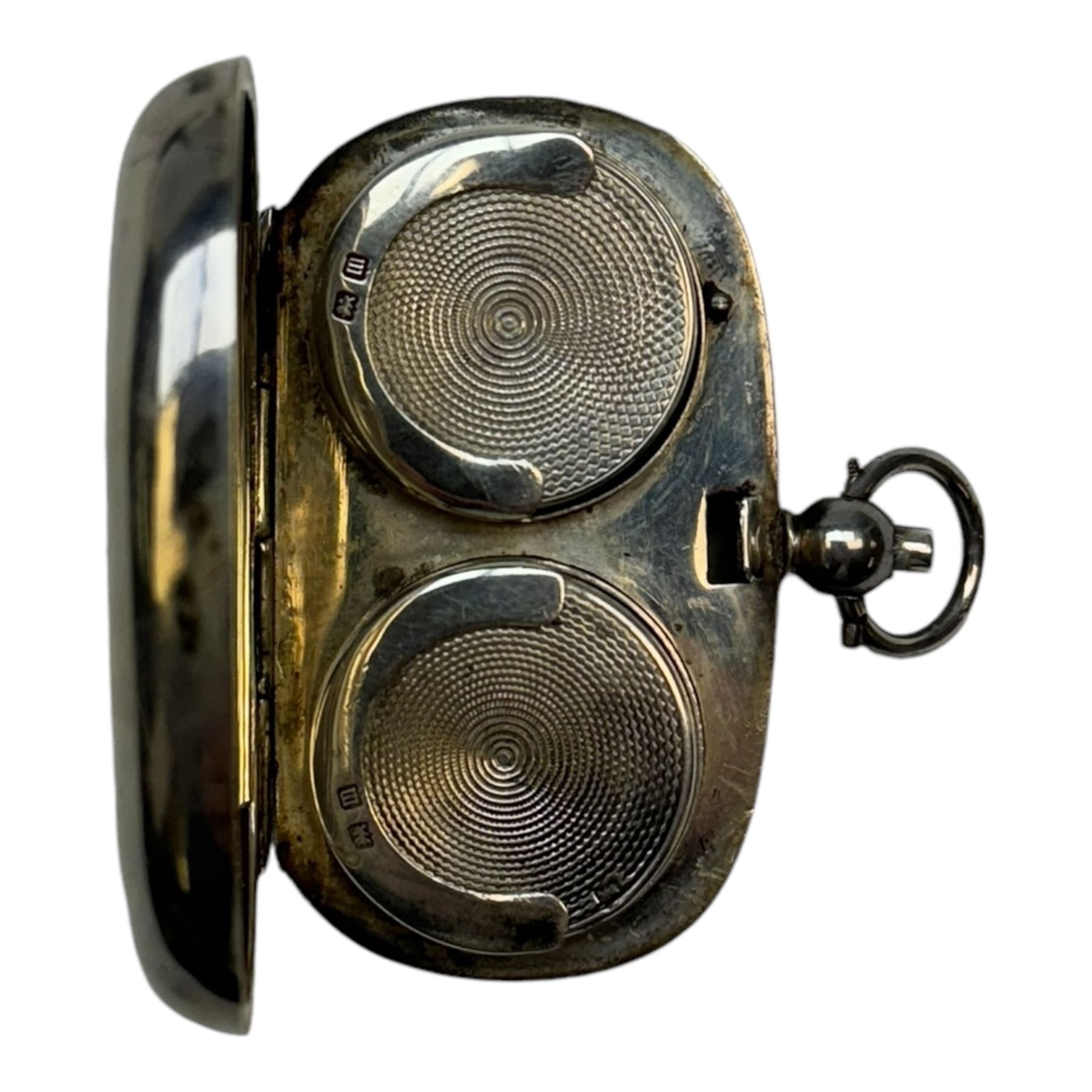 Early 20th century silver sovereign holder, of plain oval form, the hinged cover, opening to reveal two spring loaded recesses for half and full sovereigns, hallmarked Birmingham 1911, W5cm
