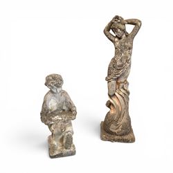 Two composition stone garden figures, comprising a seated boy figure and a standing classi...