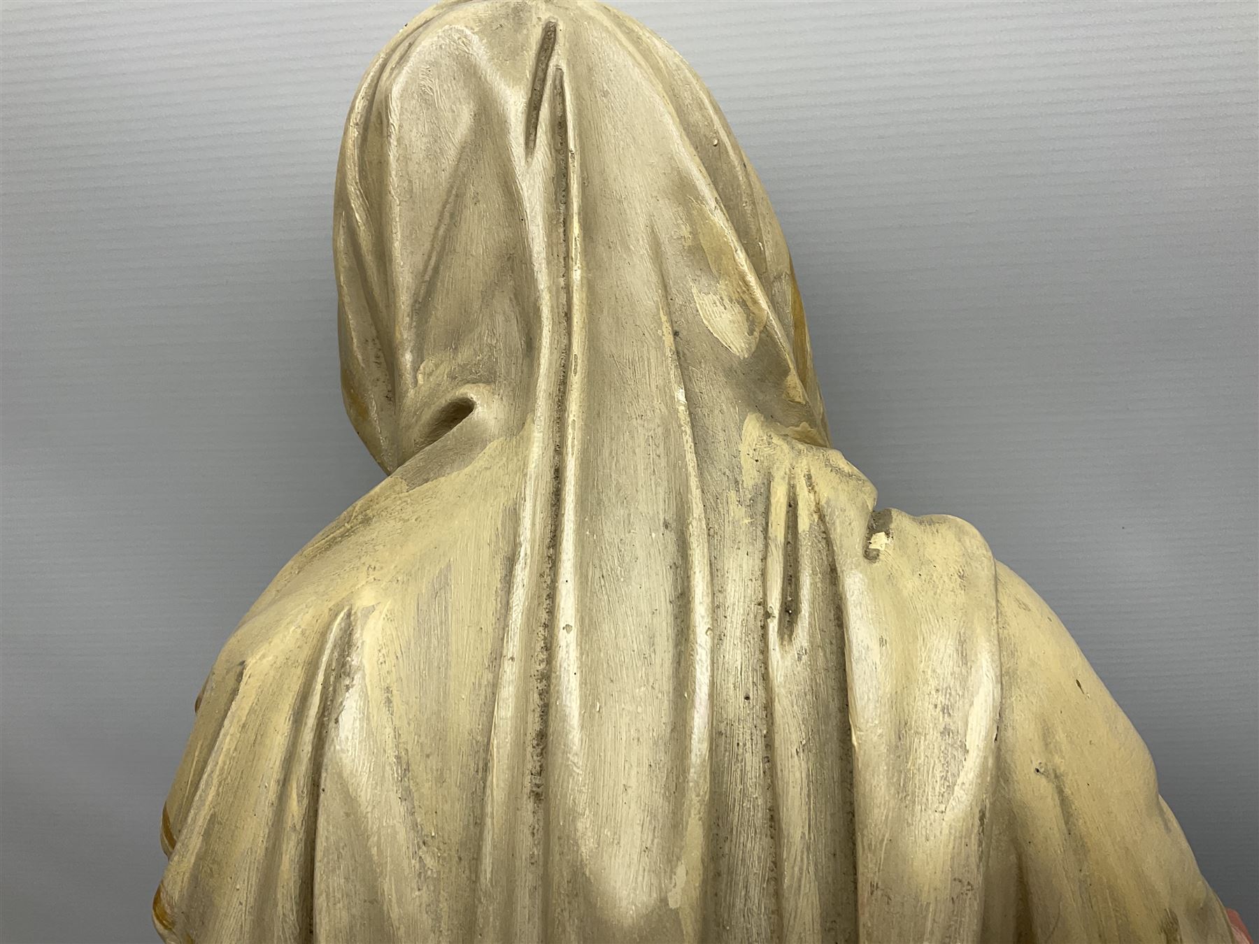 Two religious painted plaster figures of Mary and Joseph kneeling on oval plinths, with impressed mark 'Raffl et Cie Paris', H60cm 