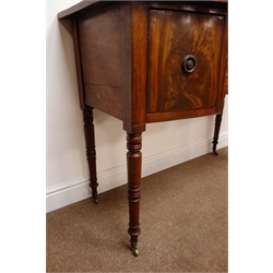  William lV mahogany bow front kneehole sideboard, two deep and one shallow drawer outlined with satin wood and ebonised stringing, brass ring handles on ring turned tapering legs with brass sockets and castors, W108cm, D52cm, H83cm  