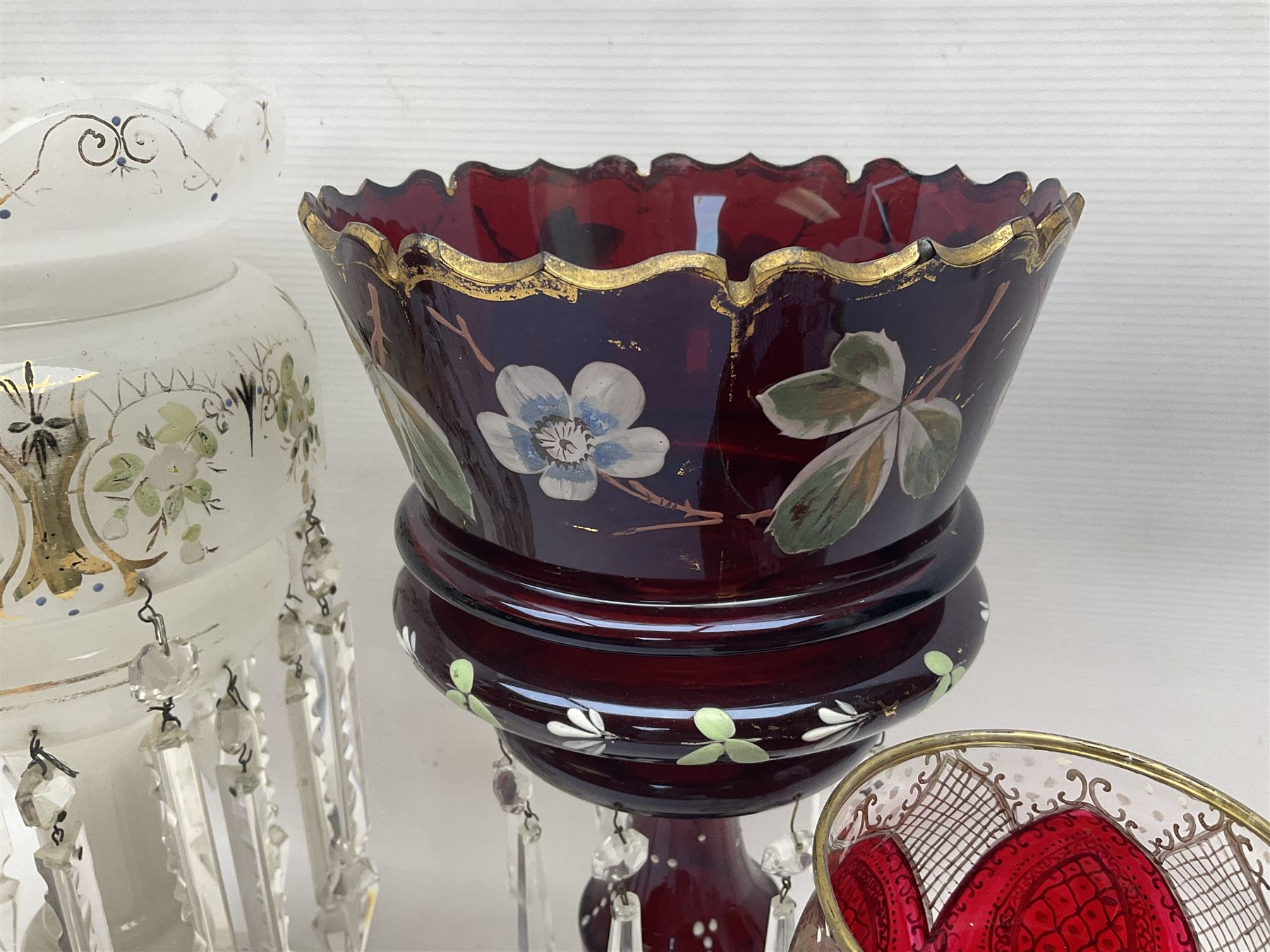 Bohemian red glass lustre, painted with stylised floral and foliate decoration, together with a milk glass example and two bohemian goblets converted to lustres 