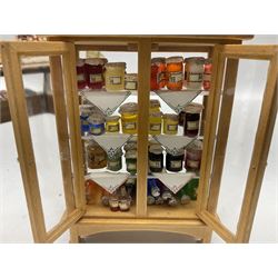 Collection of miniature dolls house grocery shop furniture and produce, comprising glazed corner counter with brass style cash register, shelved preserves unit, pies, cheese board and trays of meats, pair of white cheese counters, biscuit display with six tins, glazed preserves cabinet, pair of shop chairs and four further cheese boards complete with grapes and label flags