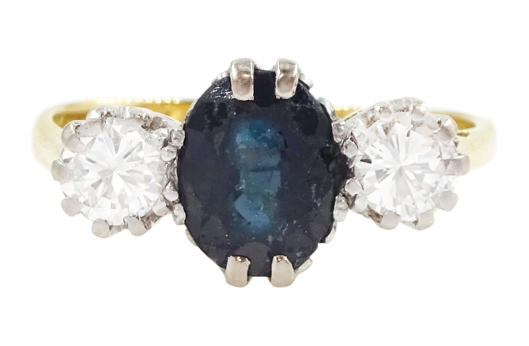 18ct gold sapphire and diamond three stone ring, single oval cut sapphire, with two round brilliant cut diamonds set either side, Sheffield 1987, total diamond weight approx 0.60 carat