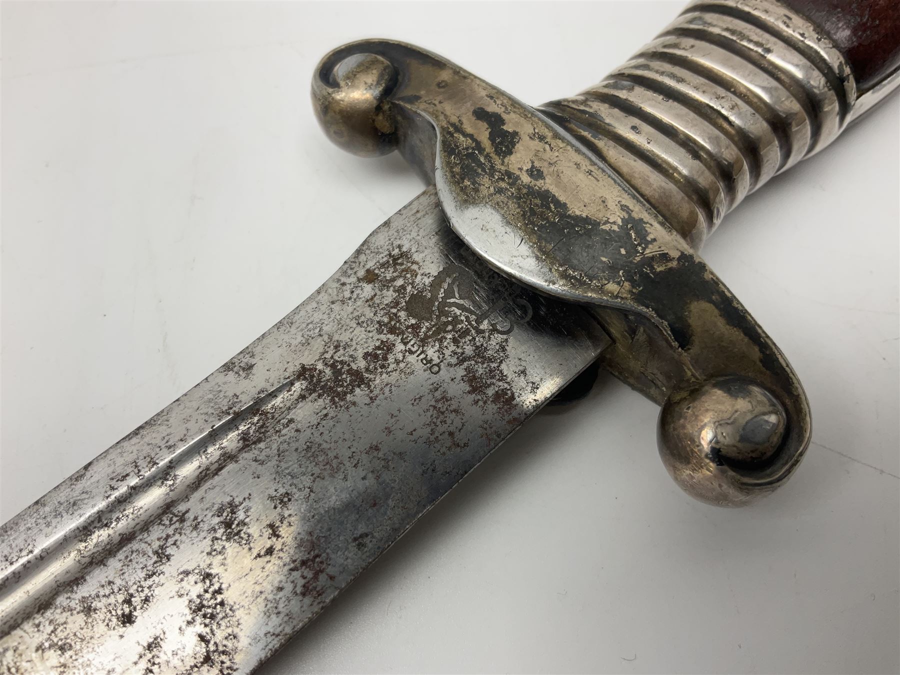 WW2 German RAD (Reichsarbeitdienst) Leader's hewer dagger,  the 25.5cm fullered steel blade engraved Arbeit Adelt (Work Enables) with Eickhorn squirrel maker's mark; scrolling cross-piece, mahogany grip and eagle pommel; in decorative plated scabbard L40cm overall.