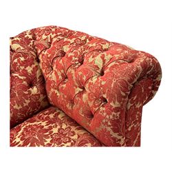 Late 20th century upholstered Chesterfield sofa, in red damask floral fabric, with deep buttoned back and arms, scrolled arms at equal height to back, on turned front supports
