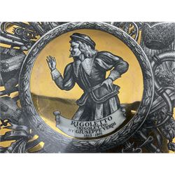 Three Fornasetti plates from the Melodramma series, each depicting a operatic portraits within a border of operatic emblems on gilt ground, with printed mark beneath, D25cm 
