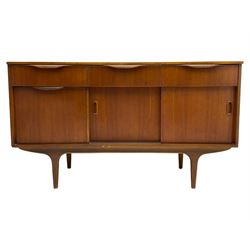 Mid-20th century circa. 1970s teak sideboard, three drawers over fall front cupboard and two sliding doors, on tapering supports