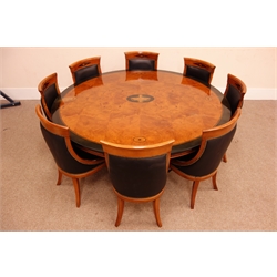  Empire style ebonised banded ash curl pedestal dining table, circular top with urn and fan inlaid panels on tapering square support with  outsplayed scroll feet, D190cm, H75cm and a set of eight dining chairs, brass nail upholstered with curved backs on sabre legs, W52cm, (9)  