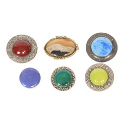 Six brooches, including one Ruskin example in silver mount, four Ruskin style brooches wit...