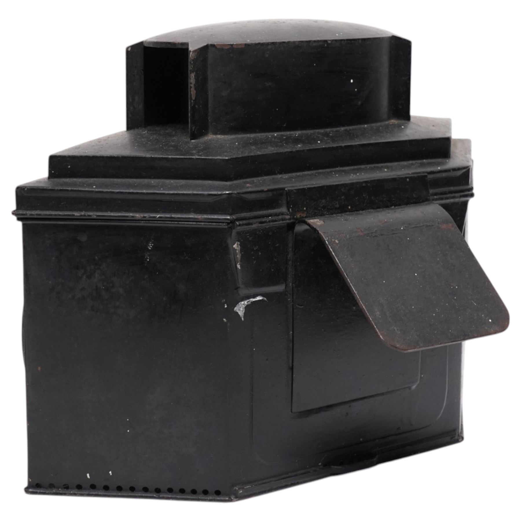 Victorian black toleware triple footboard carriage lamp of hexagonal form, with three circular bevelled lens, mounting clip to rear