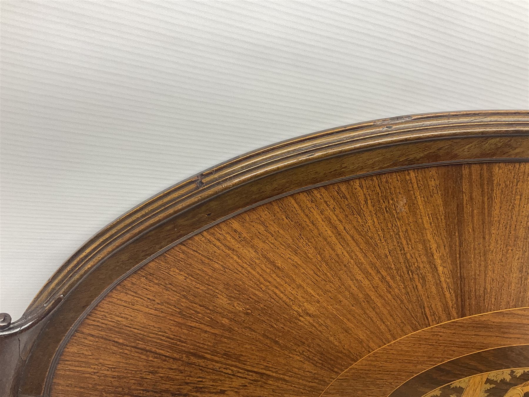 Late 19th/early 20th century mahogany and marquetry inlaid tray, of oval form with twin scrolled handles and moulded border, the central panel inlaid with figures seated at a table drinking tea, L99cm
