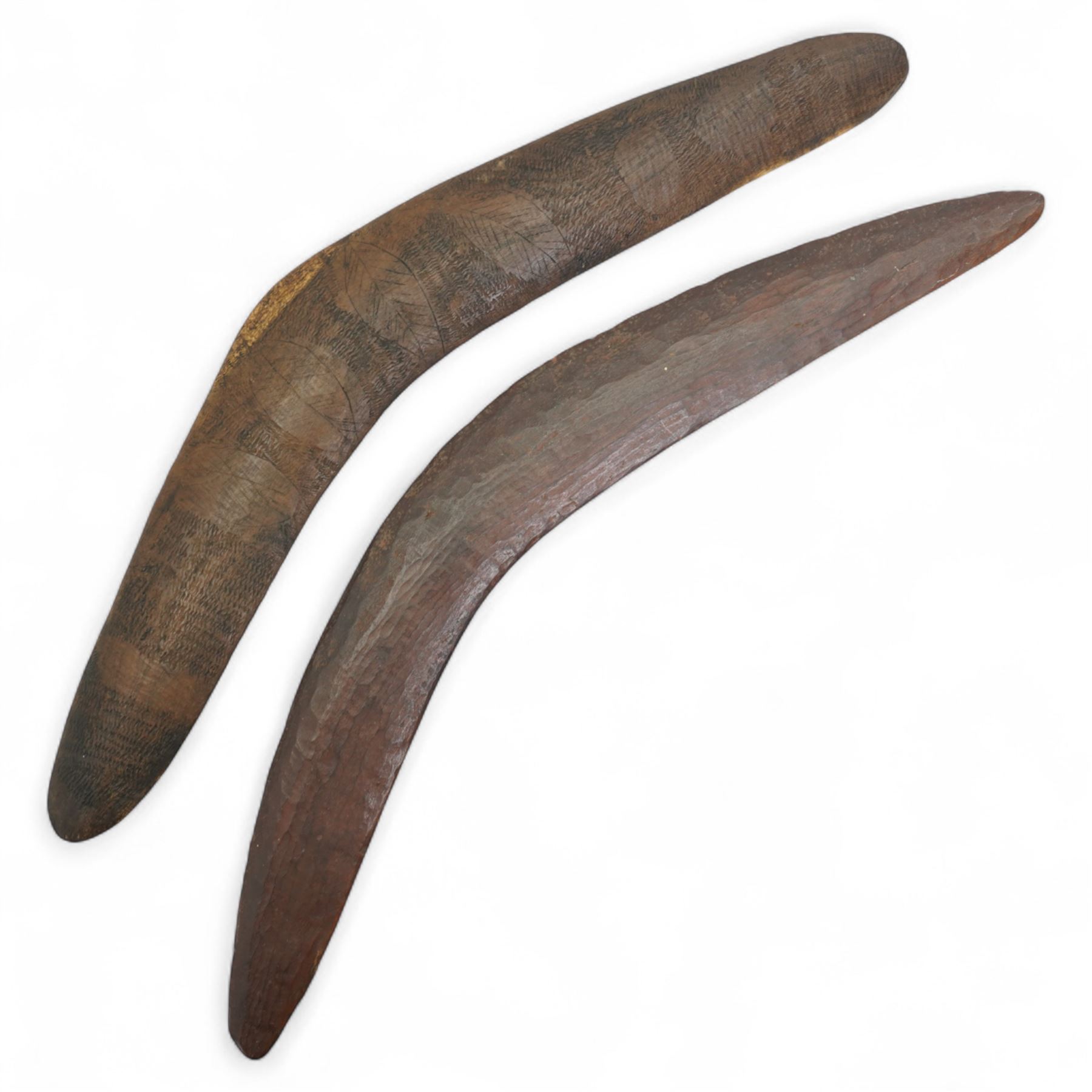 Australian Aboriginal boomerang decorated with eucalyptus leaves, a plain boomerang,  African wood and iron lamellophone and a carved wood tablet with two figures