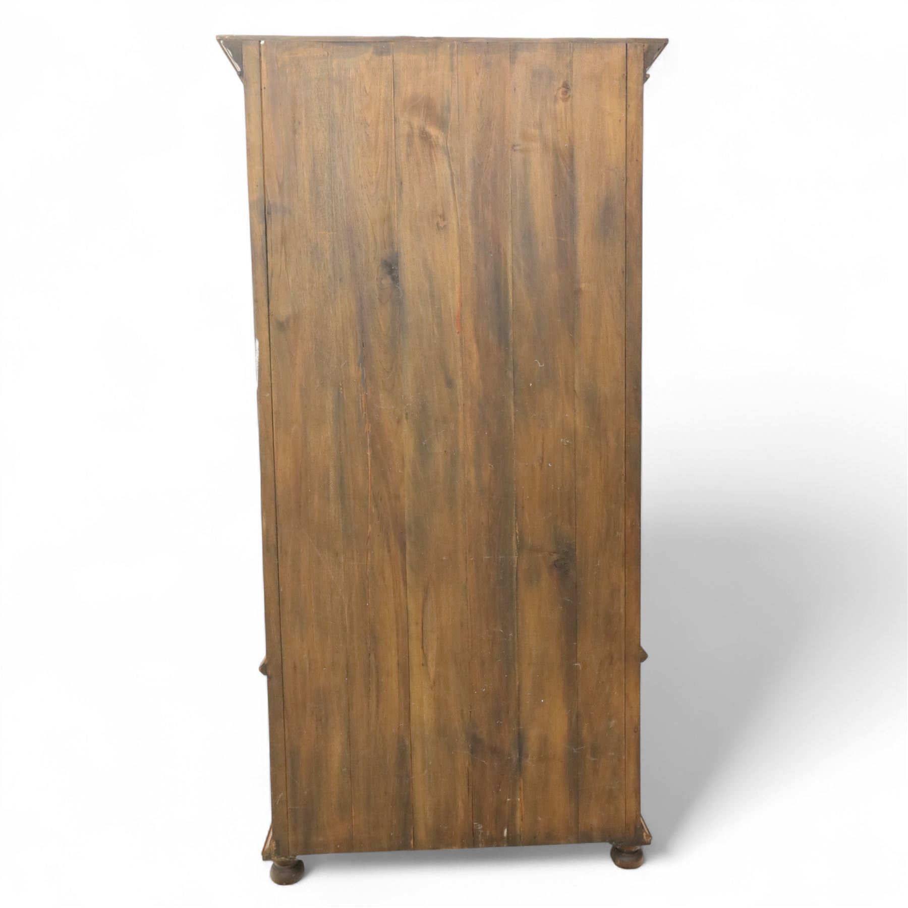 Pair of late 20th century Thai hardwood display cabinets, each with moulded cornice over twin glazed doors enclosing adjustable shelves, panelled cupboard doors below flanked by fluted columns, raised on bun feet