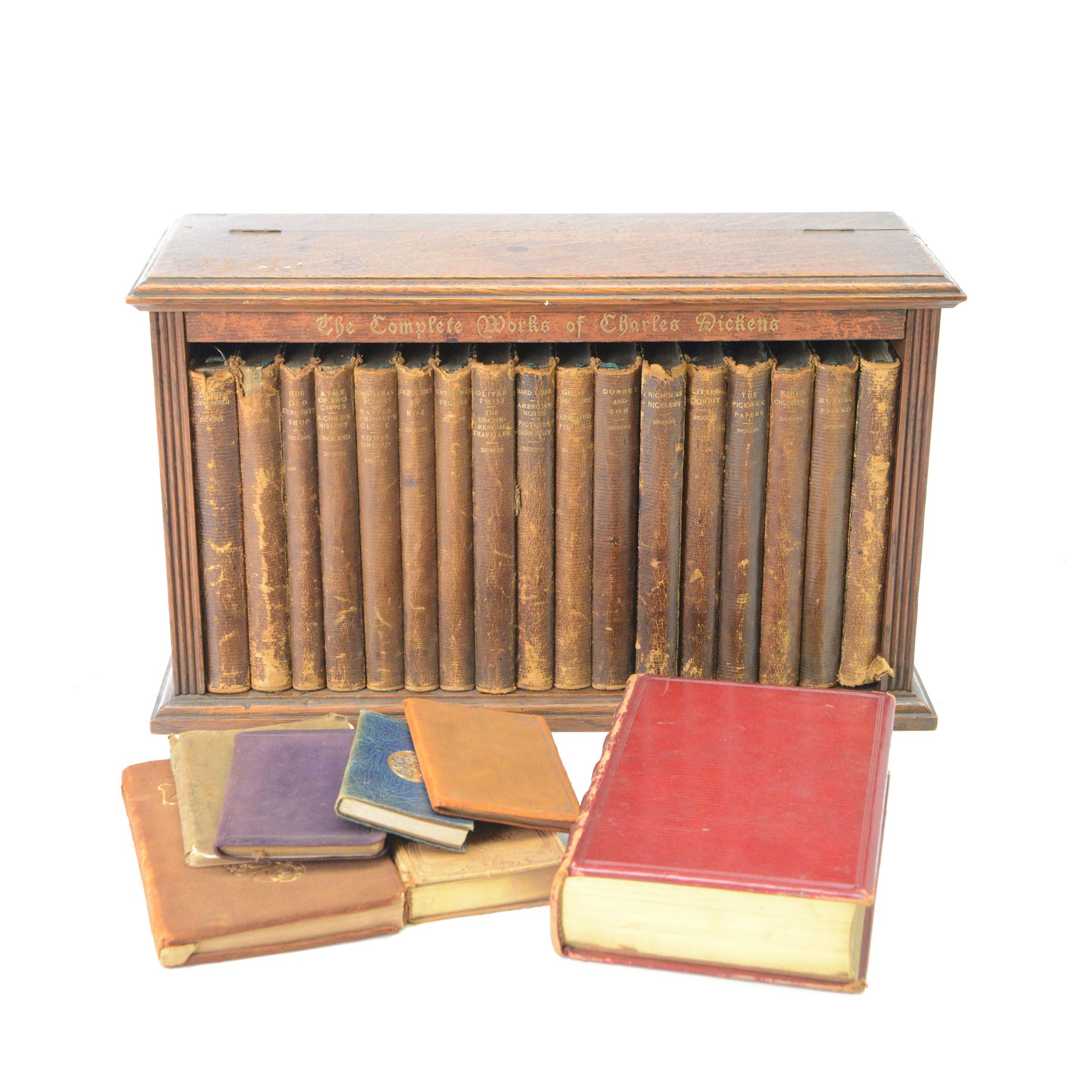 Dickens Charles, The Complete Works of Charles Dickens, 17 Vols, illustrations by 'Phiz', London, Chapman & Hall, Limited; and Henry Frowde, New York; Oxford University Press American Branch, later replaced boards, housed within an oak table top bookcase, with hinged lid, titled 'The Complete Work of Charles Dickens', together with a number of other books

