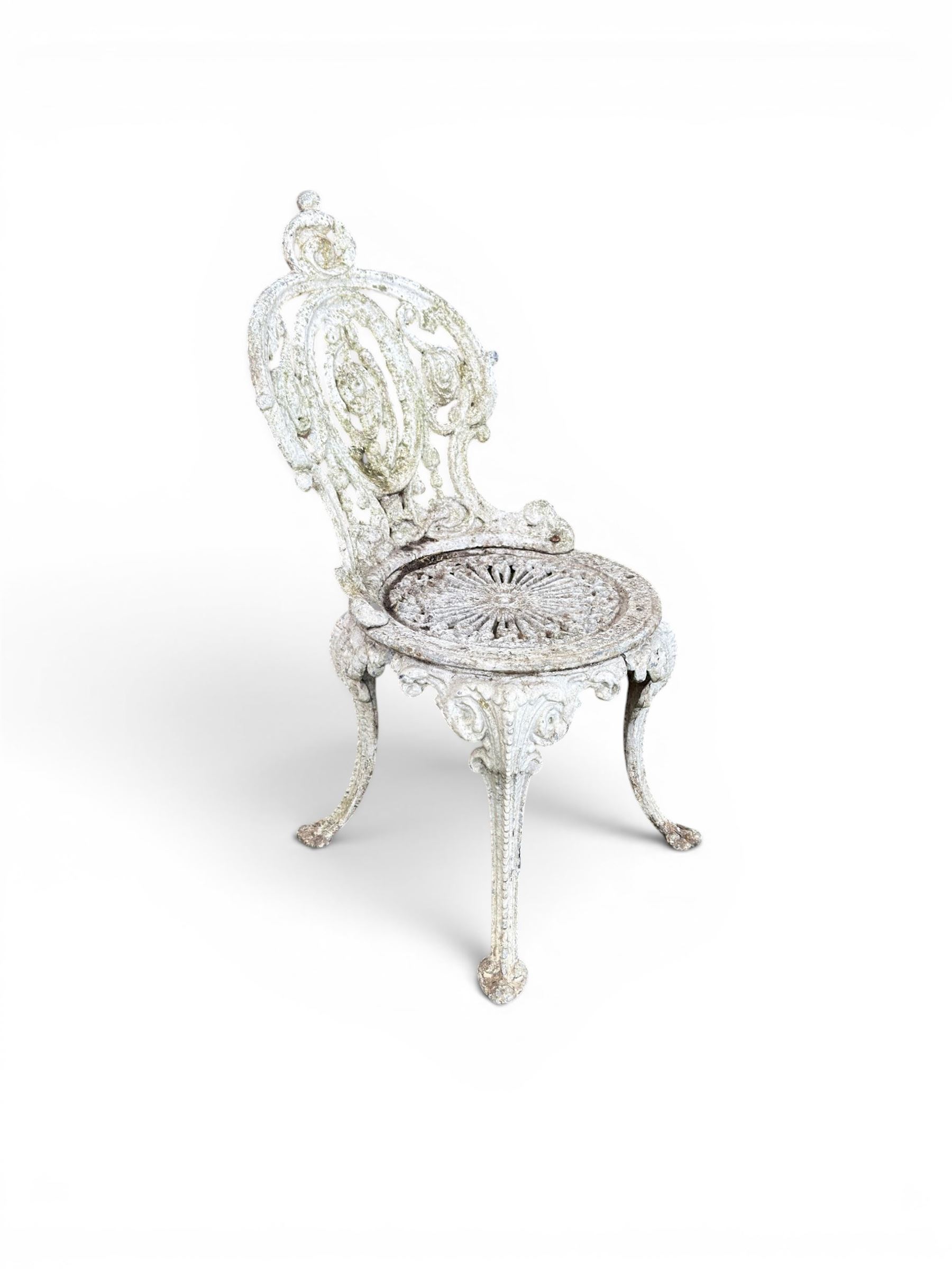 Pair of white painted cast metal garden chairs, ornate reclined backs, circular pierced seats on cabriole legs