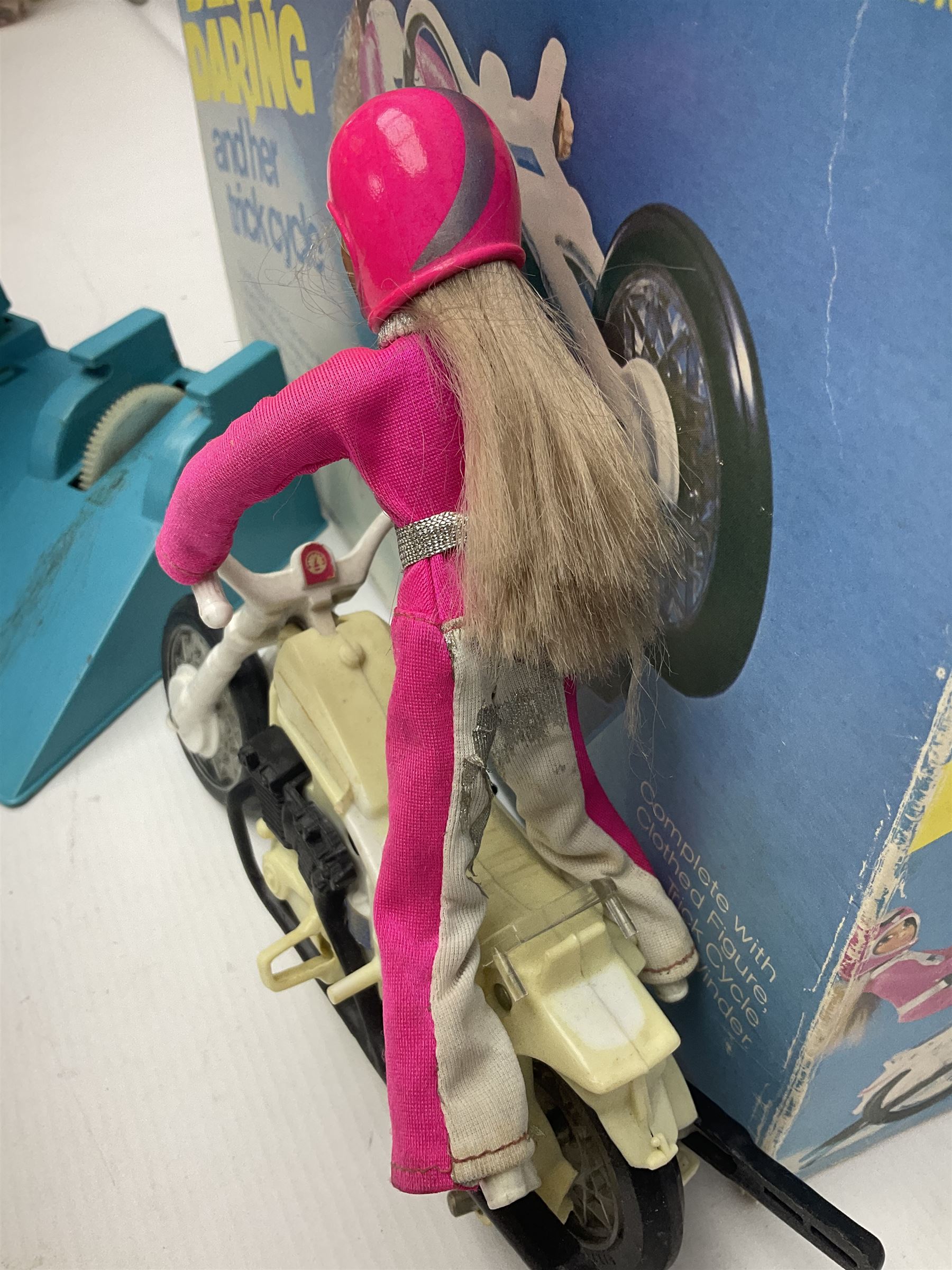 Ideal Derry Daring and Her Trick Cycle, with clothed figure on trick cycle and winder; in original illustrated box dated 1975