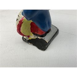 Robinson Jam plaster Golly band, including drummer and singer, H7.5cm

Originally handmade by mothers in Africa for their children from old fabric and cloth, the golly doll was adopted as the mascot and trademark for the Robertson's confectionery brand around 1910 after the company's founder John Robertson visited the US and noticed children playing with them. Robertson's Gollies have been collected by people across the UK and around the world for generations but garnered a contentious image in the 1980s because of links to racism. The trademark was removed from Robertson's branding in 2001.