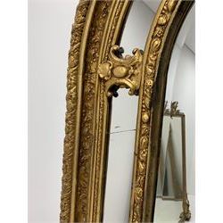 Gilt Rococo style mirror, arched top with central cartouche and oak leaf moulded pediment, floral and fruit moulded surround with segmented glass panels, bevelled central pane, c-scroll shell and acanthus leaf brackets
